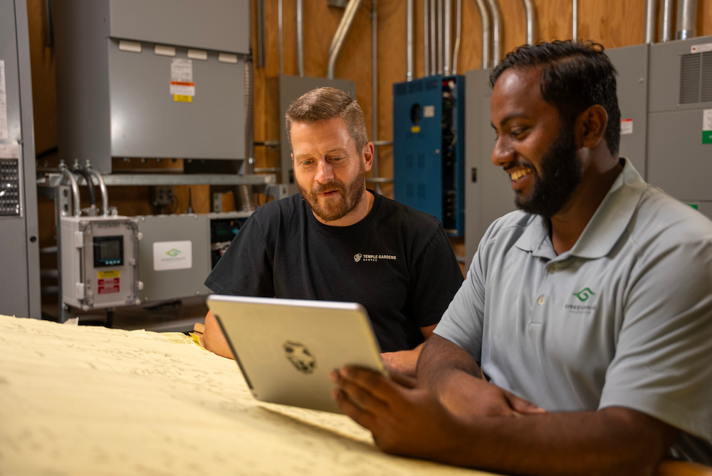 men looking at a laptop screen